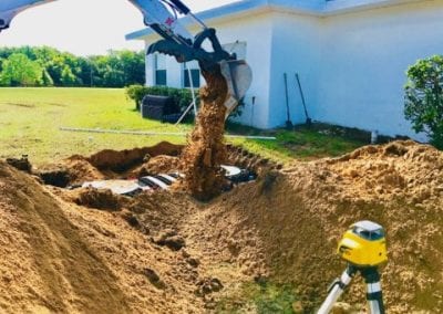 backhoe installing septic system